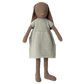 Stuffed bunny doll with a striped dress on a white background