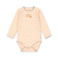 A long-sleeve baby bodysuit in a pale peach-pink color, featuring a small repeating pattern of tiny red hearts and a colorful 'maman loge' graphic on the chest. The garment has gray trim along the collar, cuffs, and leg openings, and is displayed flat against a solid white background.