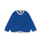 A royal blue knit cardigan sweater with white scalloped trim on the collar, cuffs, and hem, featuring decorative red and green buttons down the front, displayed on a clean white background.
