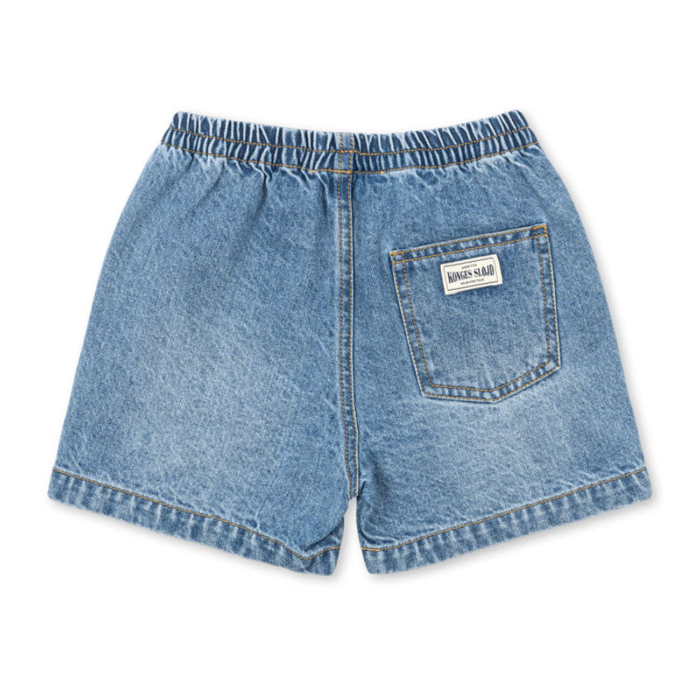 Blue denim shorts with a brand label on a white background