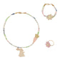 A jewellery set including a necklace, bracelet, and ring with spring and Easter themed decorations such as bunnies, carrots, and flowers.