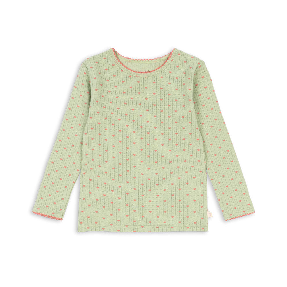 A light green long-sleeve top with a small pink floral pattern and pink trim on the collar and cuffs, displayed flat against a white background.