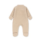 A light beige fleece footed one-piece baby jumpsuit shown from the back on a white background.