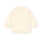 Back view of a light-colored sweater on a white background