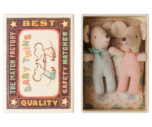 A matchbox-style gift set shown open, containing two small plush mouse toys dressed in light blue and pink gingham outfits with bow ties, alongside the illustrated matchbox lid.
