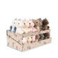 A retail display box filled with small plush stuffed animals, including white, pink, brown, gray, and blue unicorns and bears, on a plain white background.