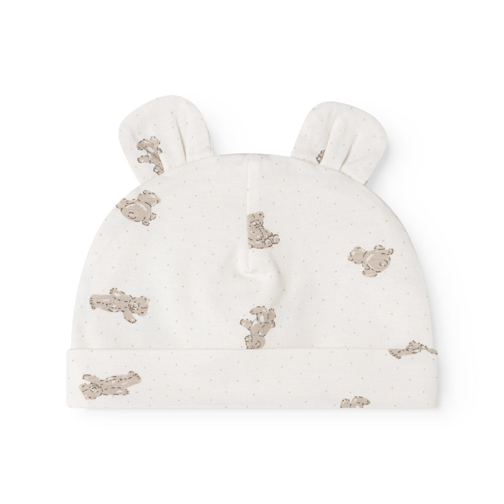 An off-white knit baby hat with small ear tufts and an allover print of teddy bears in a muted brownish-gray color, shown against a plain white background.