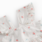 Floral patterned fabric with ruffled edges on a white background
