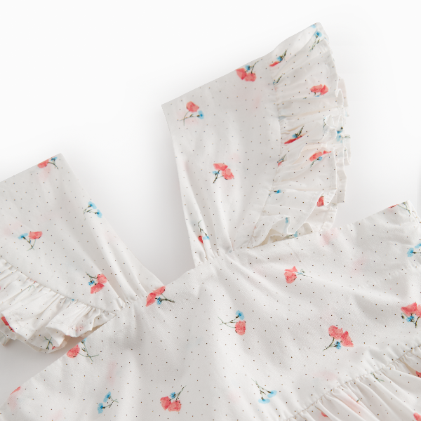 Floral patterned fabric with ruffled edges on a white background