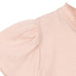 Close-up of a girls light pink blouse with ruffled sleeves on a white background