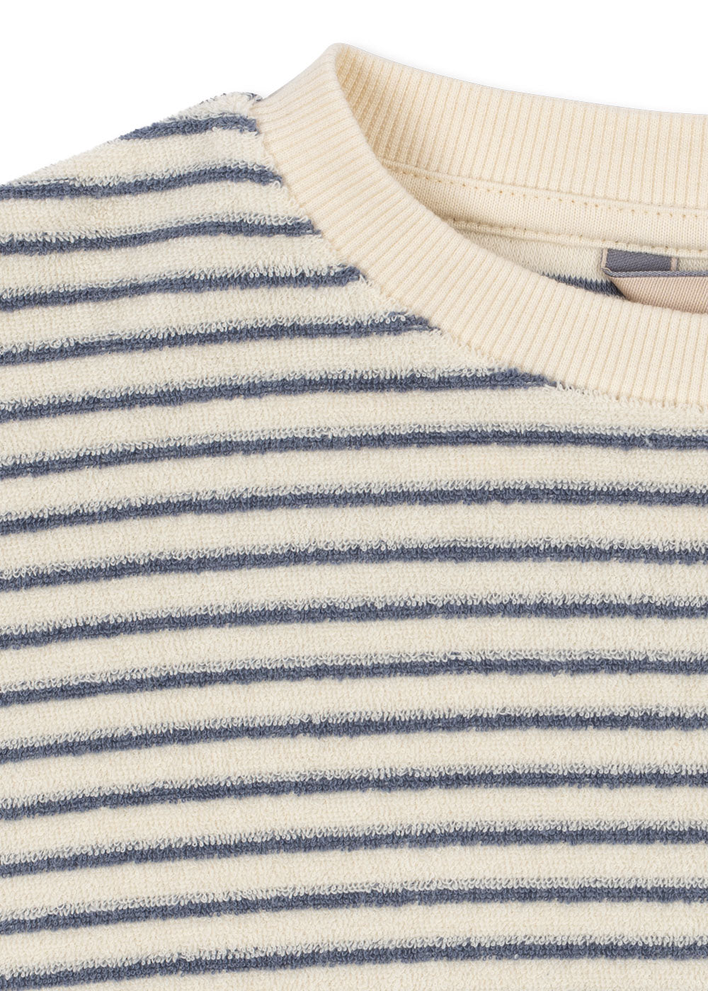 Close-up of a striped knit top with horizontal navy blue stripes on an off-white base, featuring a ribbed cream crew neck.