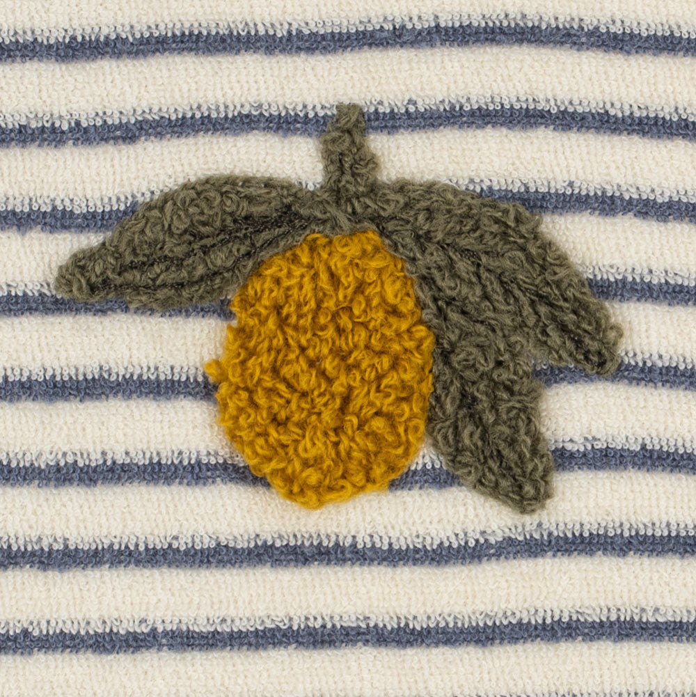 Close-up of a striped knit fabric with horizontal navy and off-white bands, featuring a crocheted or knitted acorn motif in olive green and mustard yellow on the chest.