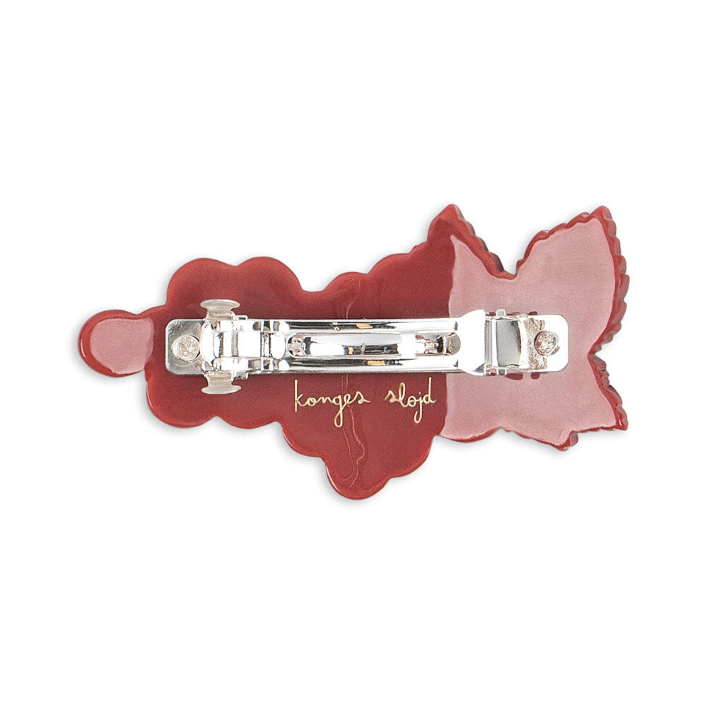 Red hair clip with a silver clasp on a white background