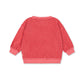 Pink striped sweater on a white background