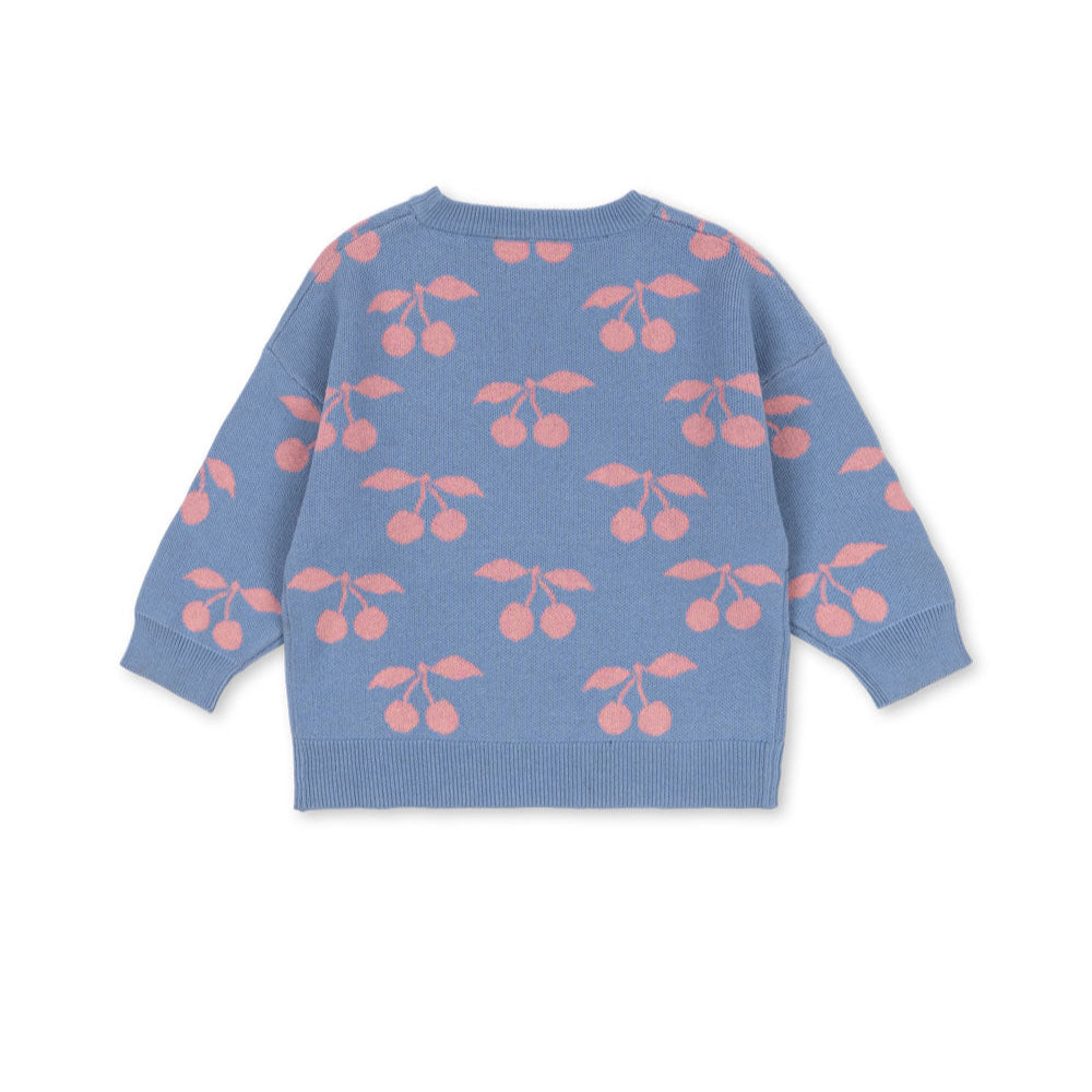 Blue sweater with pink cherry pattern on a white background