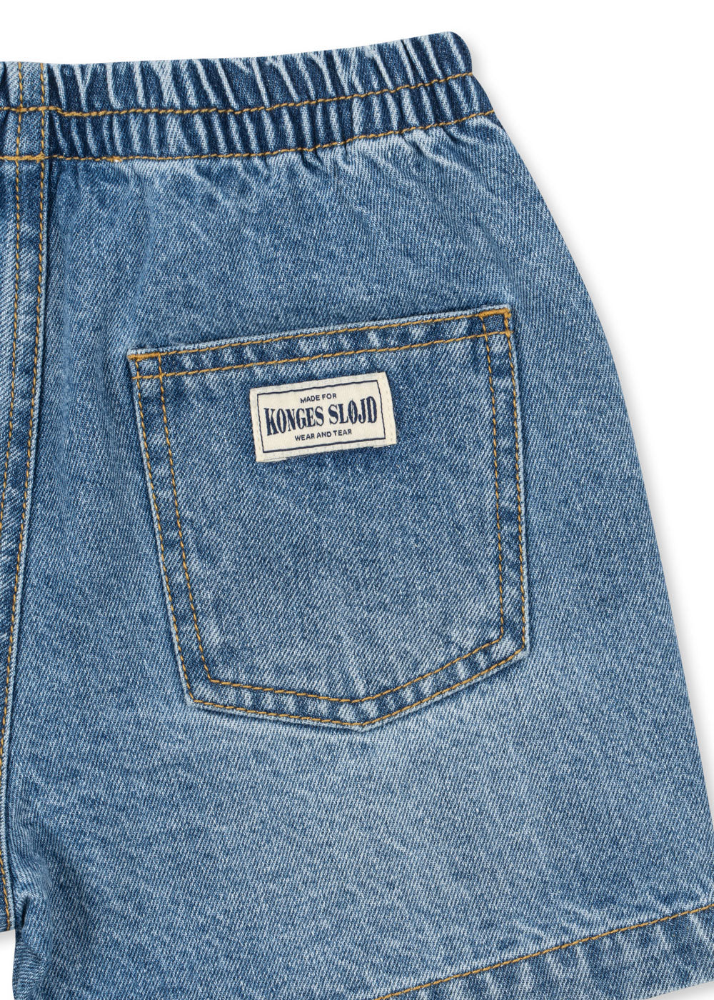 Close-up of blue denim shorts with a brand label on the pocket against a white background