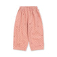 Pink pajama pants with a subtle pattern on a white background