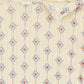Close-up of a textured fabric with a floral pattern on a beige background