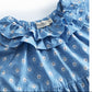 Blue floral dress with ruffled details on a white background