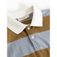 A close-up of a striped polo shirt by MatMar, featuring a white knit collar, a brown upper section, and a light blue lower section, with a two-button placket.