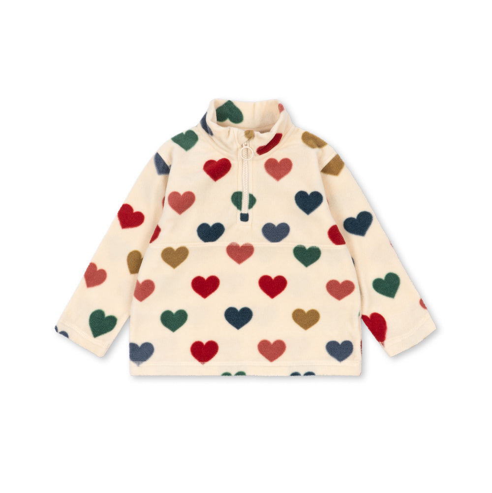 A cream-colored long-sleeve quarter-zip fleece pullover with an all-over pattern of small hearts in red, green, navy, and brown, displayed flat against a white background.