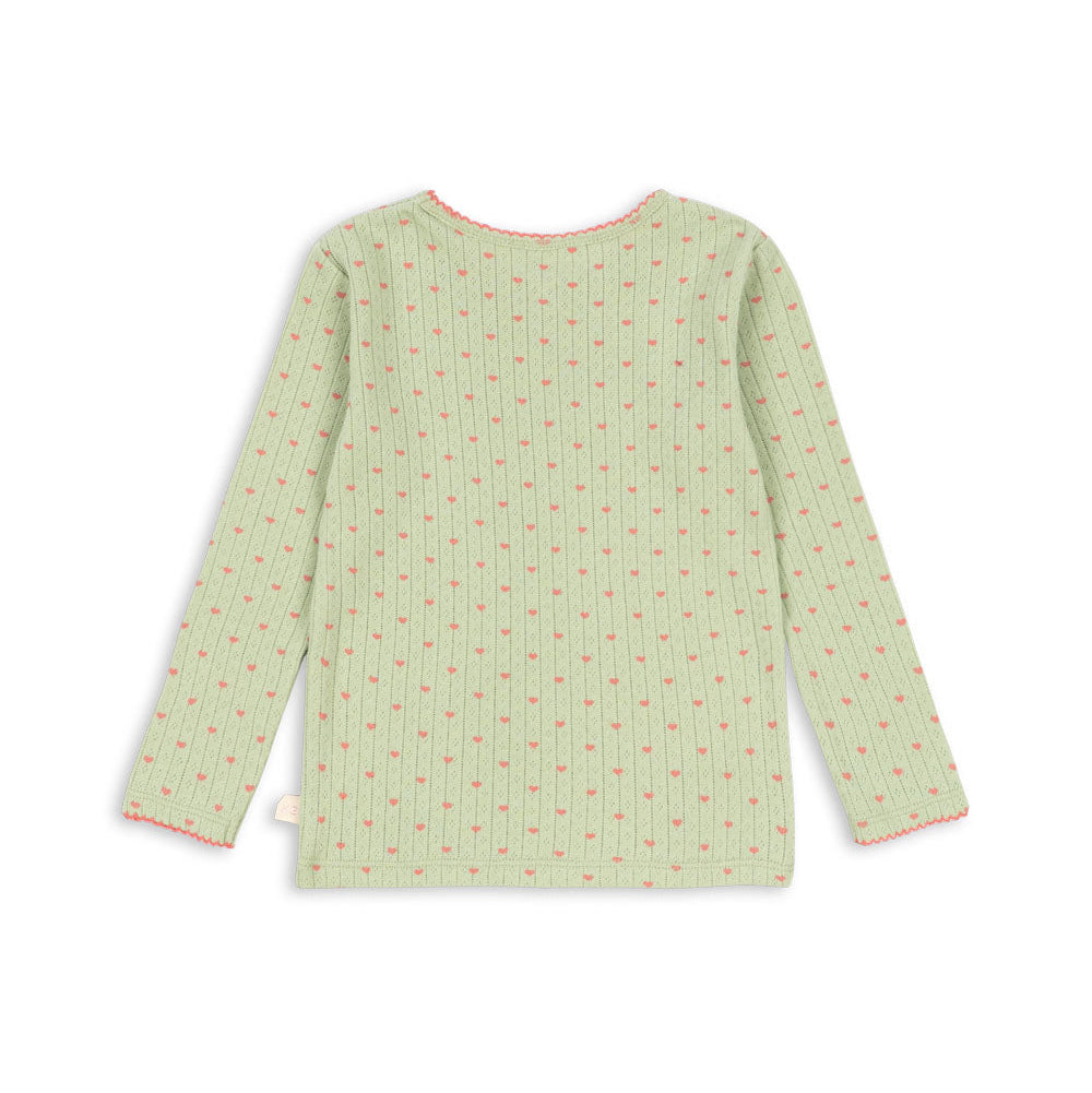 A light green long-sleeve top with a small repeating floral pattern in pink and green, shown flat against a white background.