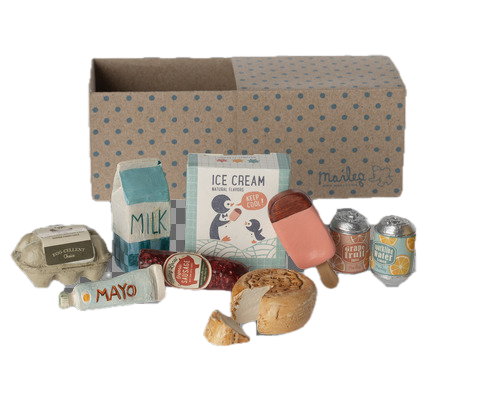 Set of toy food items and packaging in front of a cardboard box with a pattern.