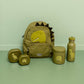 Dinosaur-themed backpack and accessories on a green surface with a light green background