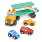 Wooden toy truck with a flatbed carrying smaller toy cars on a white background