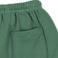 Close-up of green organic cottob boys pants with a pocket on a white background