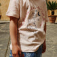 Girl wearing Era org a t-shirt with a cat design outdoorsnic cotton
