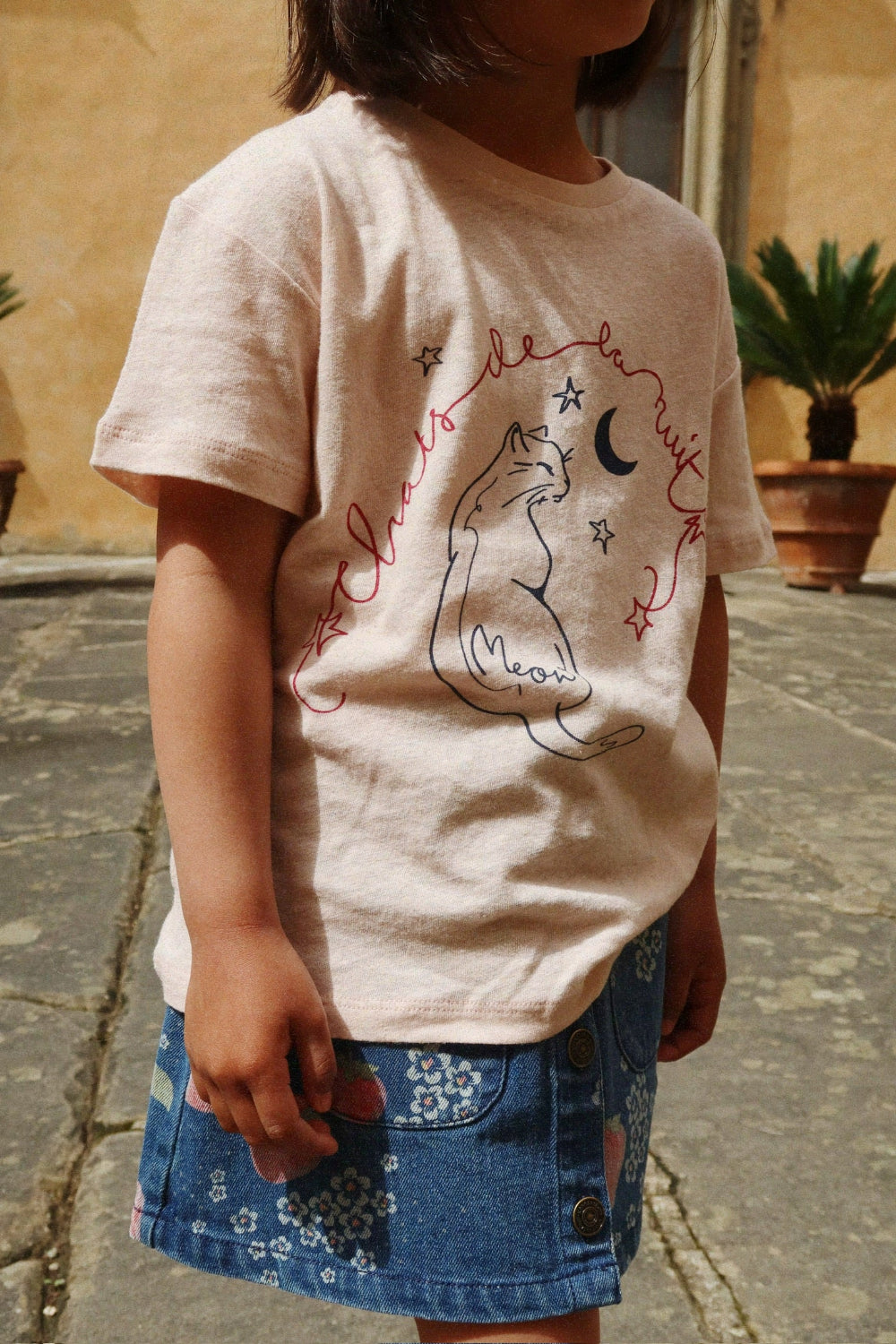 Girl wearing Era org a t-shirt with a cat design outdoorsnic cotton