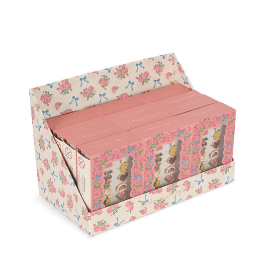 Floral-patterned box containing small bottles with pink caps on a white background