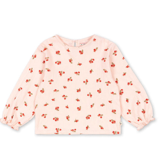 Pink long-sleeve top with small red floral pattern on a white background