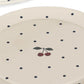 Beige ceramic plate with black polka dots and cherry design on a white background