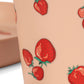 Strawberry tattoos on a person's arm with a blurred background