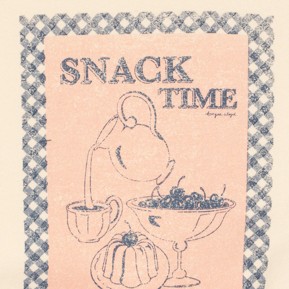 Decorative kitchen towel with 'SNACK TIME' text and illustrations of a teapot, cake, and grapes on a checkered border.