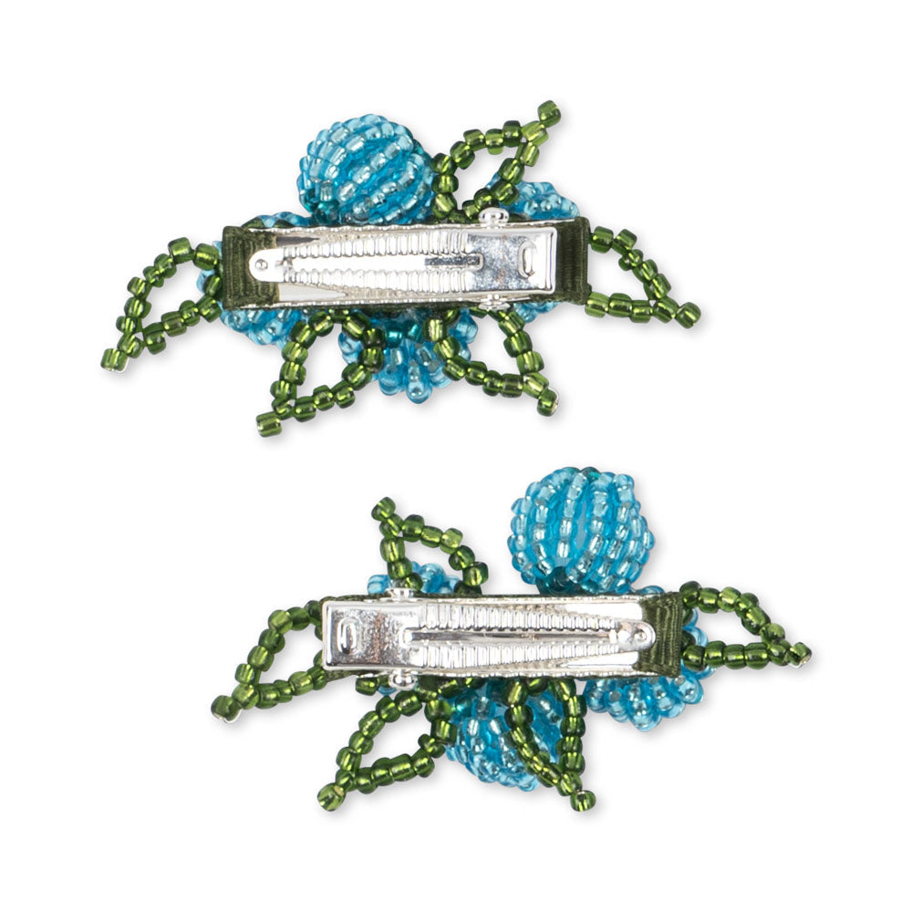 Two decorative hair clips with blue and green beads on a white background