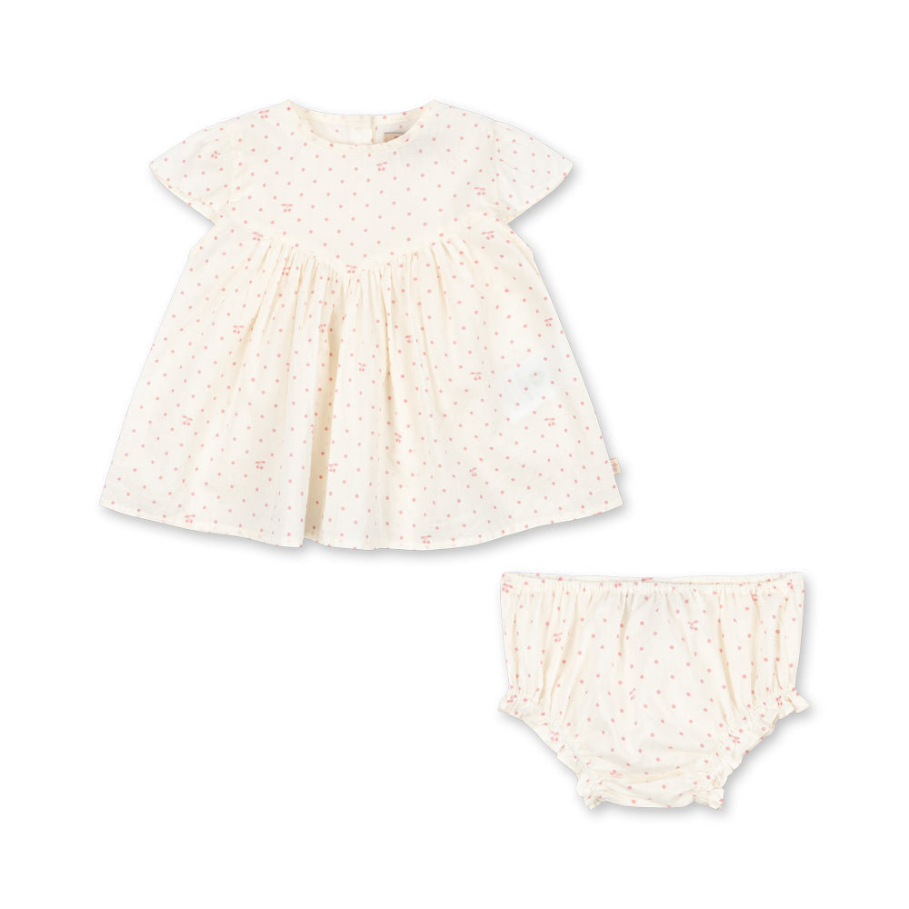 Baby dress and bloomers set with lace details on a white background