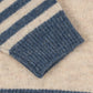 Close-up of a blue and beige striped fabric with a textured pattern.