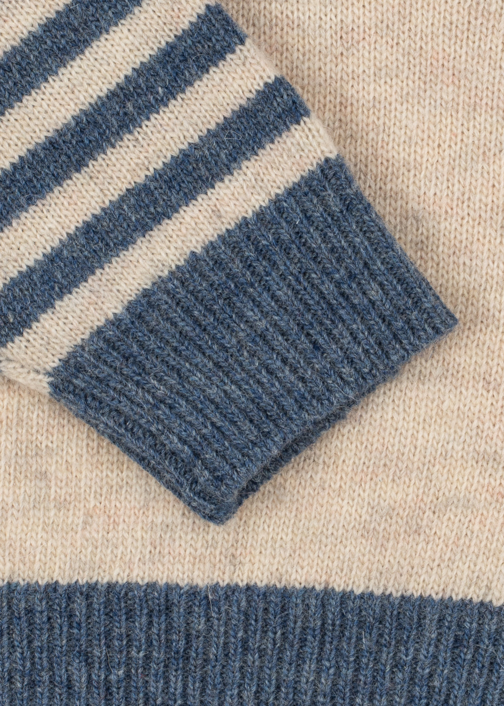 Close-up of a blue and beige striped fabric with a textured pattern.