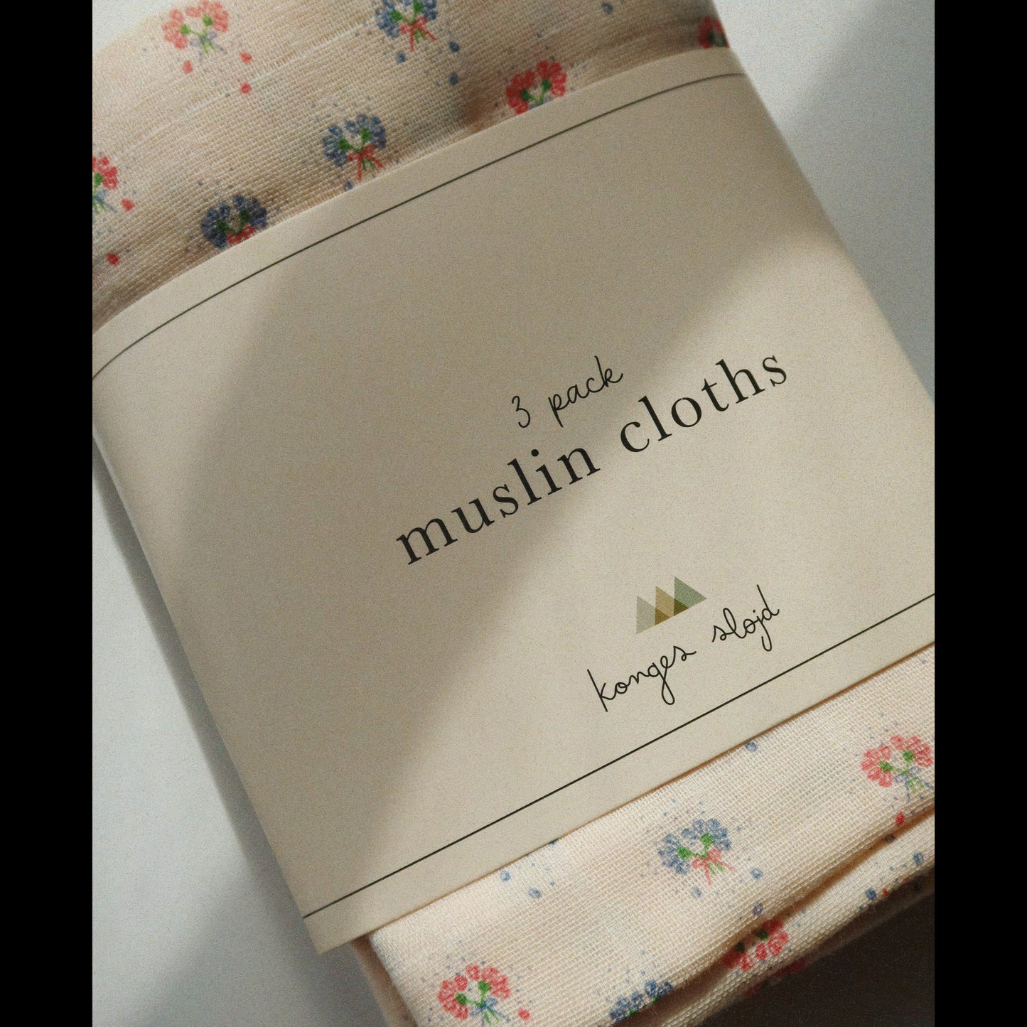 Pack of muslin cloths with floral design on a white surface