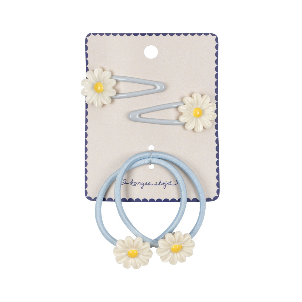 Set of hair ties with floral designs on a branded card against a white background