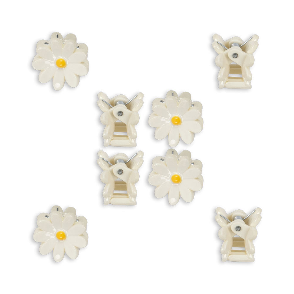 Set of white hair clips with floral designs on a white background
