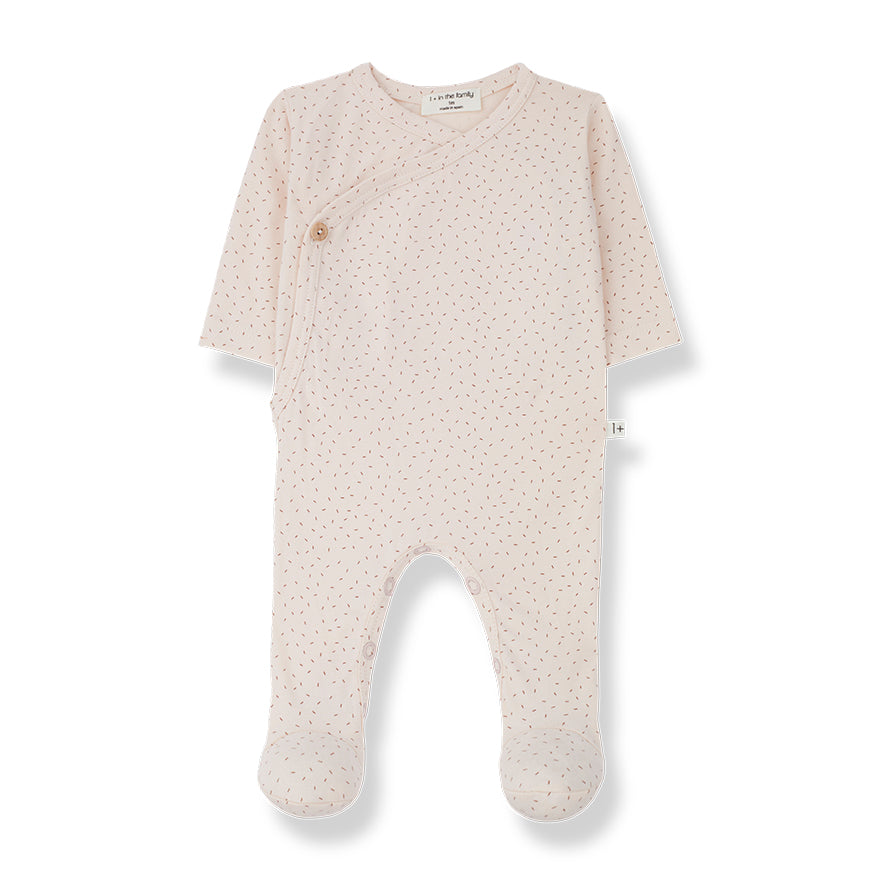 a light pink baby grow woth crossover body aith button details, snappers on the legs for easy changing.